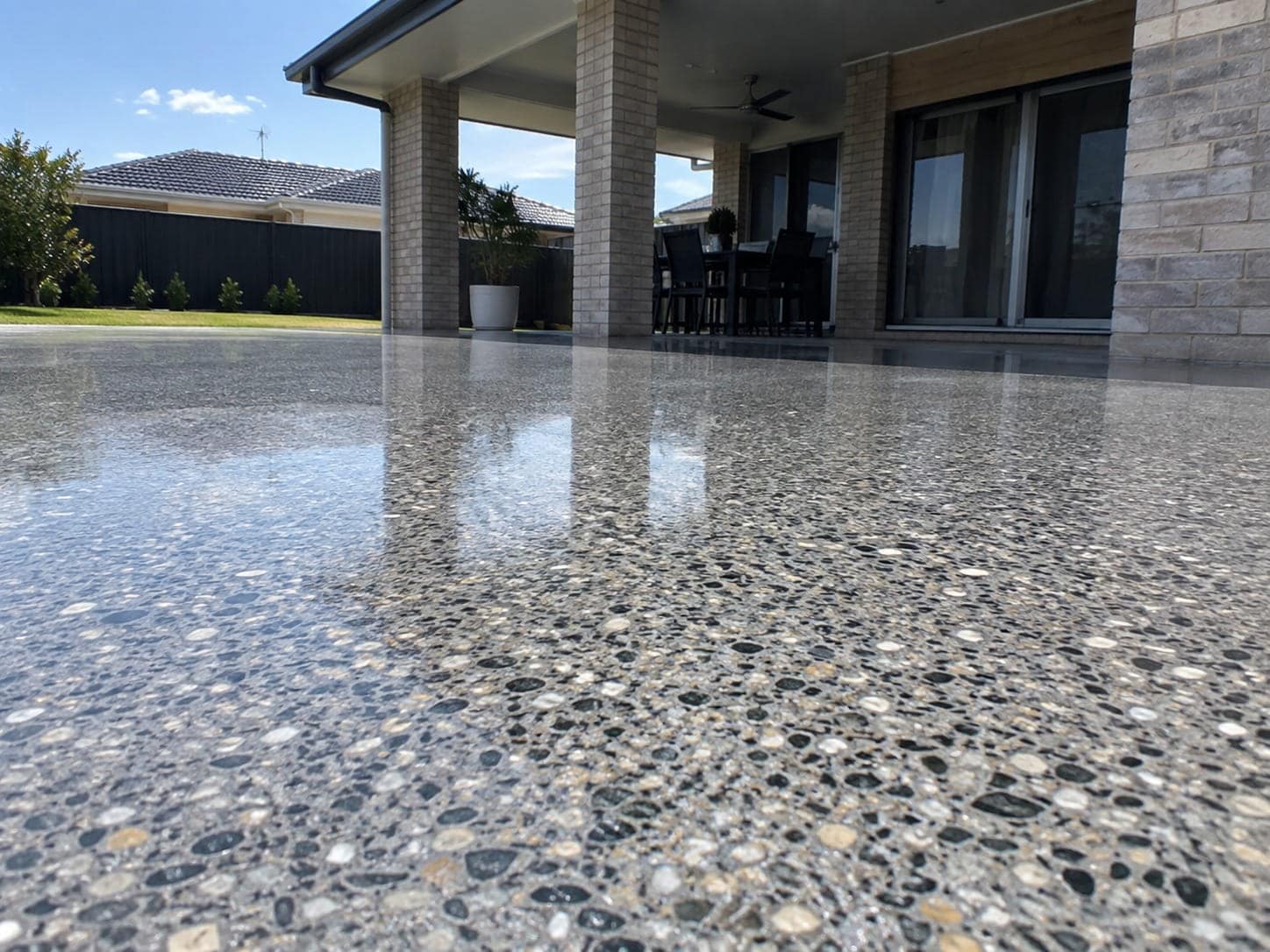 Polished exposed aggregate concrete alfresco reflecting the house at a Mandurah home