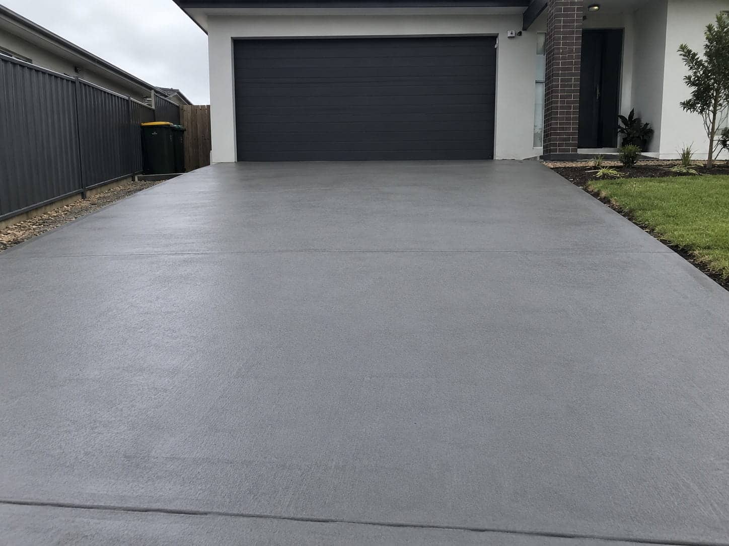 Broom-finished concrete driveway running to the garage of a Mandurah home