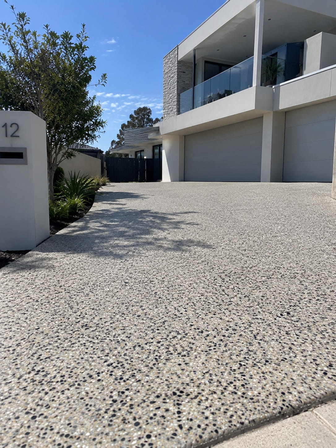 Exposed aggregate paving running alongside a two-storey Mandurah home